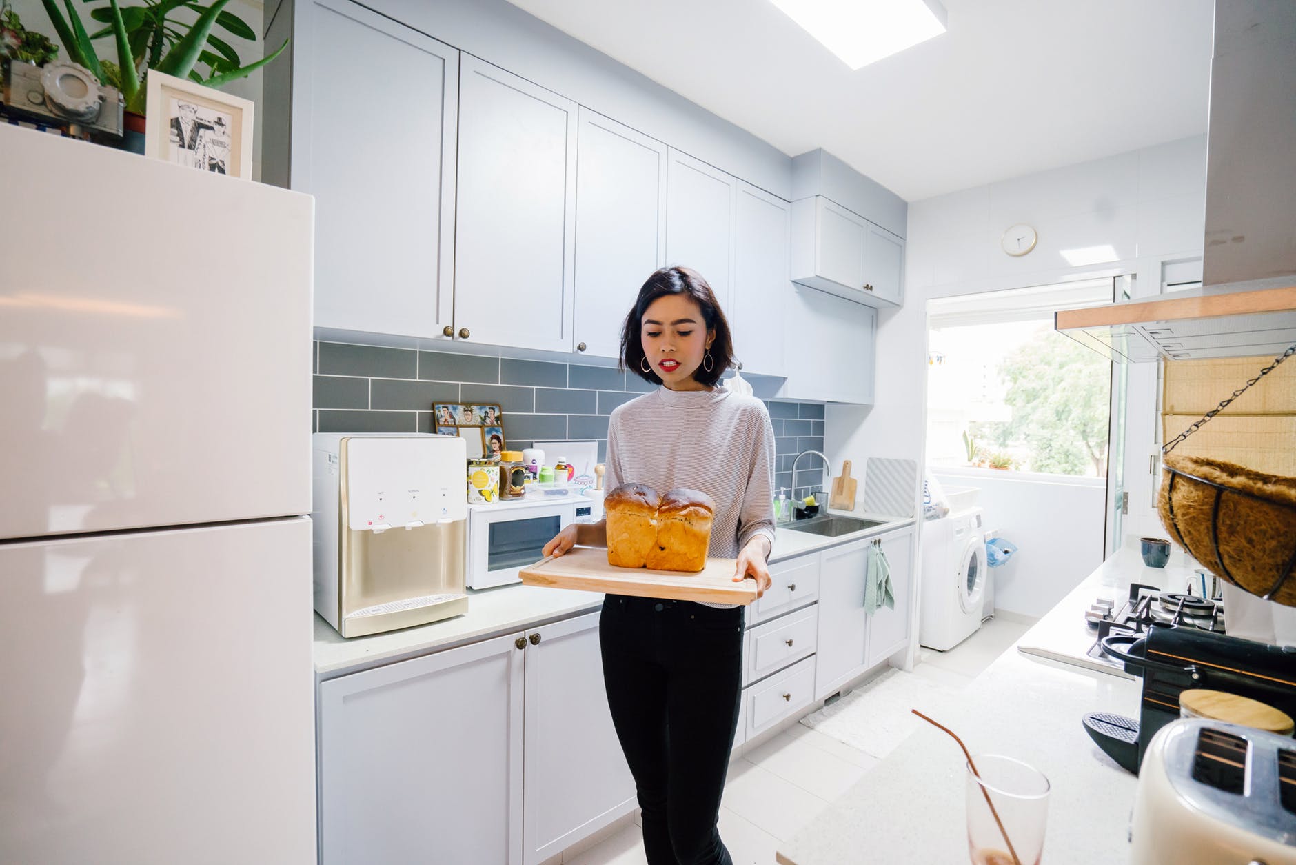 woman standing holding chopping board