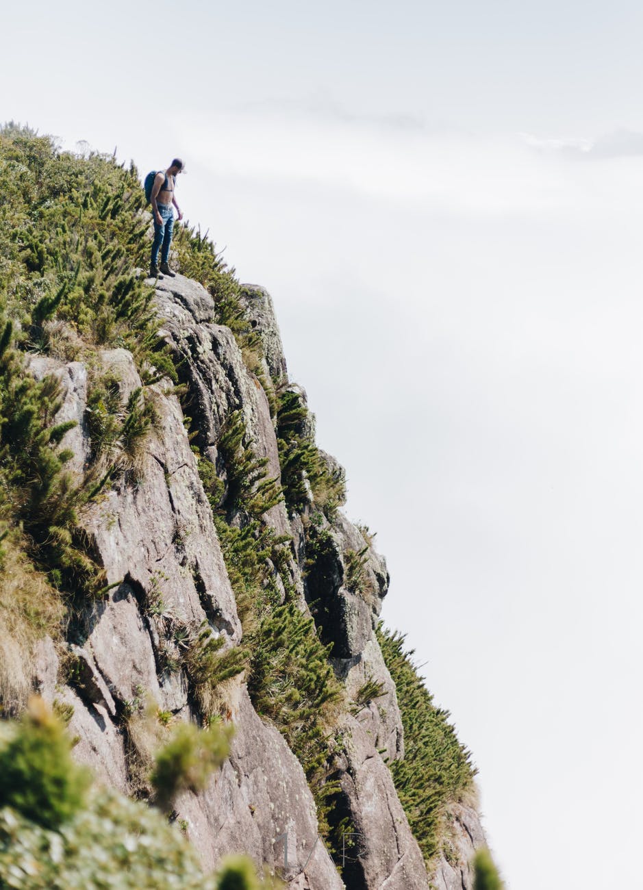 man standing on cliff