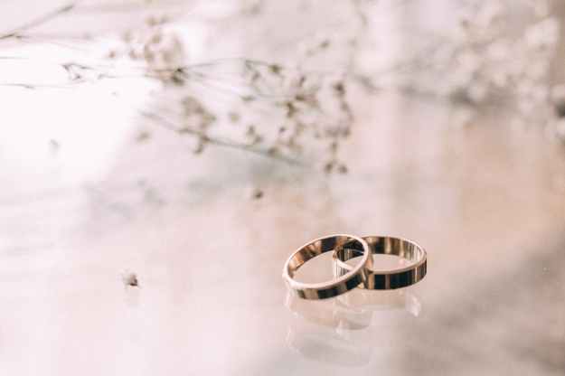 two silver colored rings on beige surface